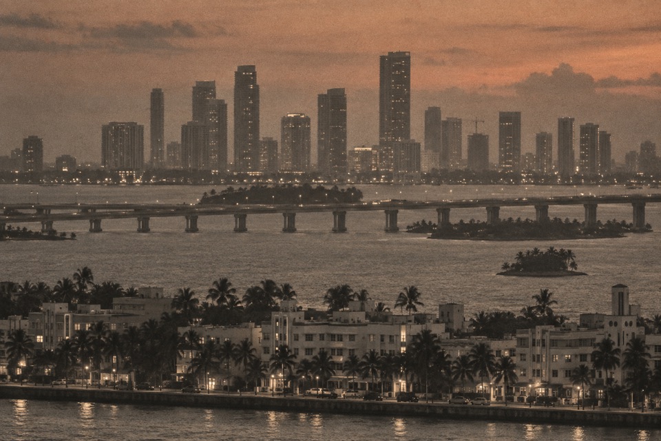 Telephoto photo of a coastal city skyline at dusk, printed like a surveillance photo